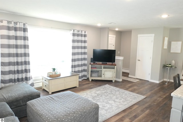 5661 Golfridge Rd, Alma, MI 48801 - living room featuring a wealth of natural light, baseboard heating, baseboards, and dark wood-style flooring