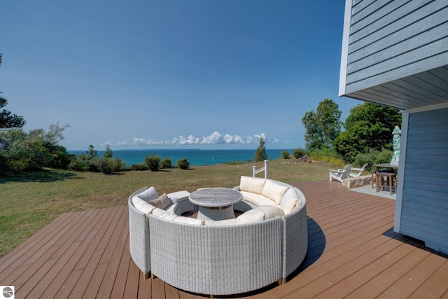 4781 E Golfview Dr, Leland, MI 49654 - wooden terrace featuring a lawn, outdoor lounge area, and a water view