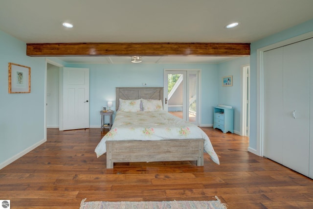 4781 E Golfview Dr, Leland, MI 49654 - bedroom with baseboards, wood finished floors, and beam ceiling