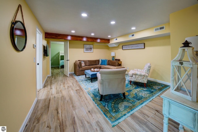 4781 E Golfview Dr, Leland, MI 49654 - living area with baseboards, wood finished floors, and visible vents