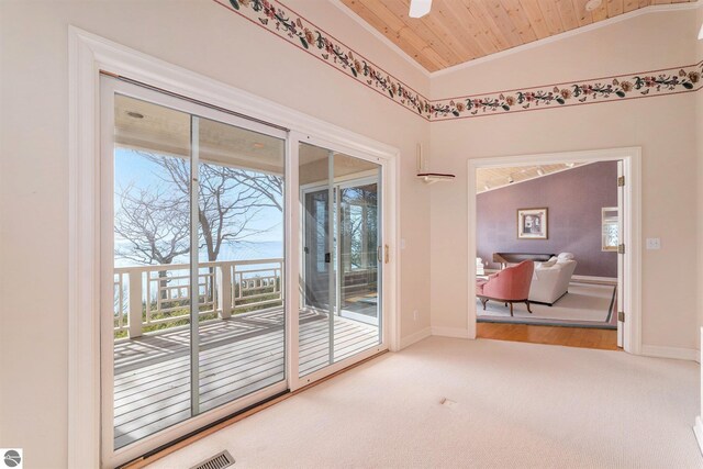 interior space with baseboards, carpet floors, ornamental molding, vaulted ceiling, and wood ceiling