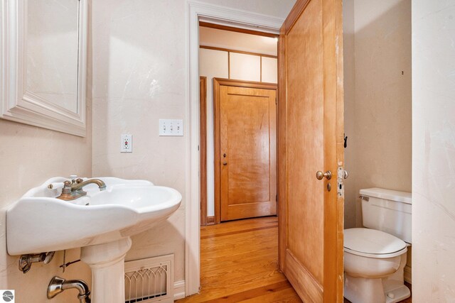 bathroom featuring toilet and wood finished floors