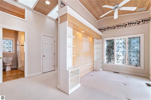 interior space with visible vents, carpet, wooden ceiling, and high vaulted ceiling