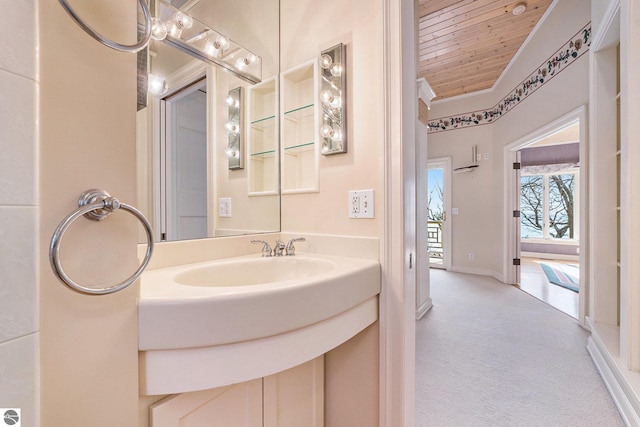 bathroom with vanity, wooden ceiling, and baseboards