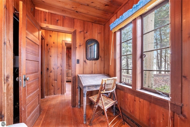 office featuring wooden walls, wood ceiling, and hardwood / wood-style flooring