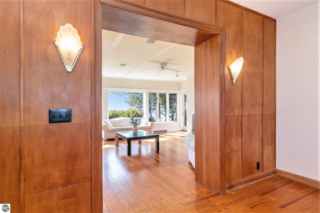 hallway featuring light wood-type flooring and baseboards