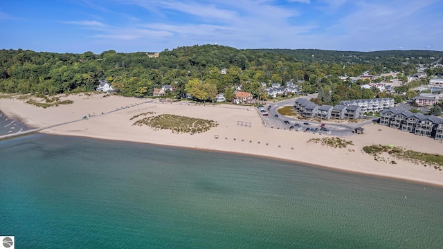 bird's eye view with a wooded view, a beach view, and a water view
