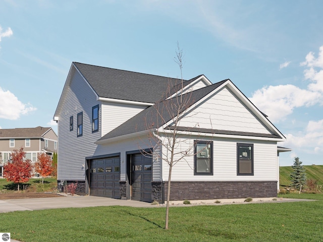 view of home's exterior with driveway, roof with shingles, an attached garage, stone siding, and a lawn