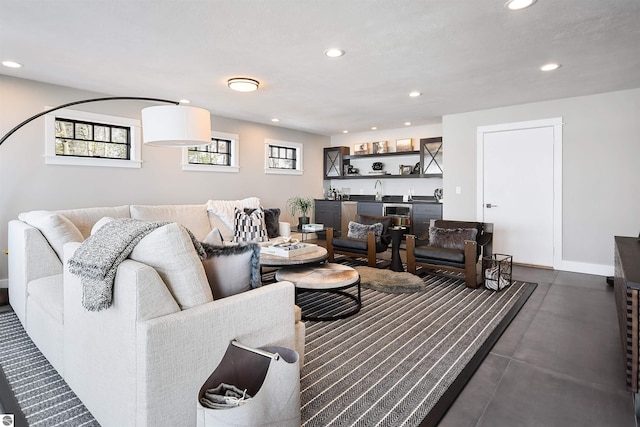5568 Lakeview Dr, Interlochen, MI 49643 - living room featuring bar with sink, recessed lighting, concrete flooring, and baseboards