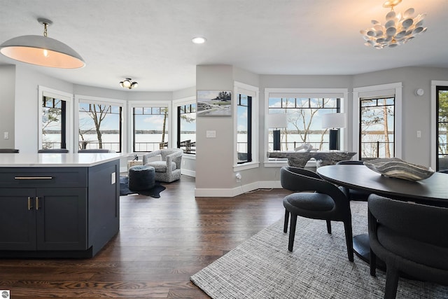 5568 Lakeview Dr, Interlochen, MI 49643 - dining space with dark wood finished floors, a chandelier, baseboards, and recessed lighting