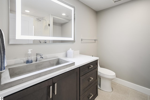 5568 Lakeview Dr, Interlochen, MI 49643 - full bathroom featuring tile patterned floors, vanity, toilet, baseboards, and a tile shower