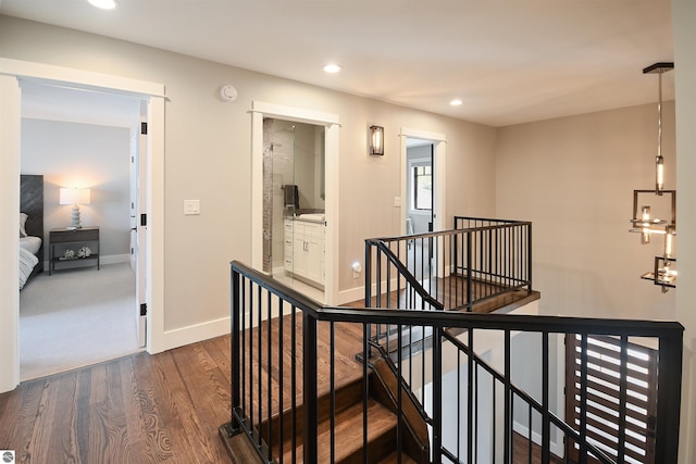5568 Lakeview Dr, Interlochen, MI 49643 - hall featuring an upstairs landing, dark wood-type flooring, recessed lighting, and baseboards
