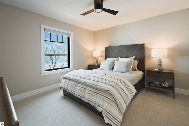 5568 Lakeview Dr, Interlochen, MI 49643 - bedroom with baseboards, light carpet, and ceiling fan