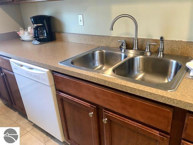5525 Golfview Ct Unit 10, Williamsburg, MI 49690 - kitchen with light tile patterned flooring, white dishwasher, and a sink