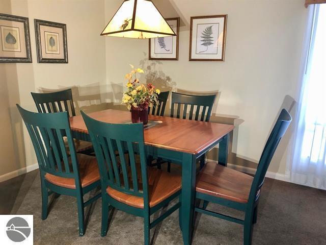 5525 Golfview Ct Unit 10, Williamsburg, MI 49690 - dining area with baseboards