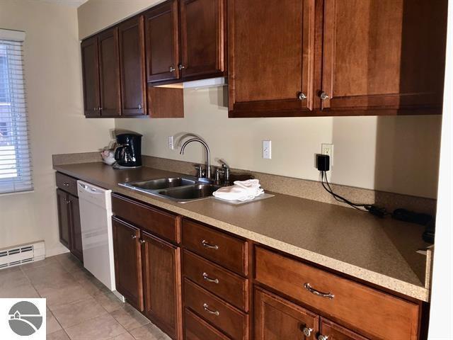 5525 Golfview Ct Unit 10, Williamsburg, MI 49690 - kitchen with a sink, a baseboard radiator, dishwasher, and light tile patterned floors