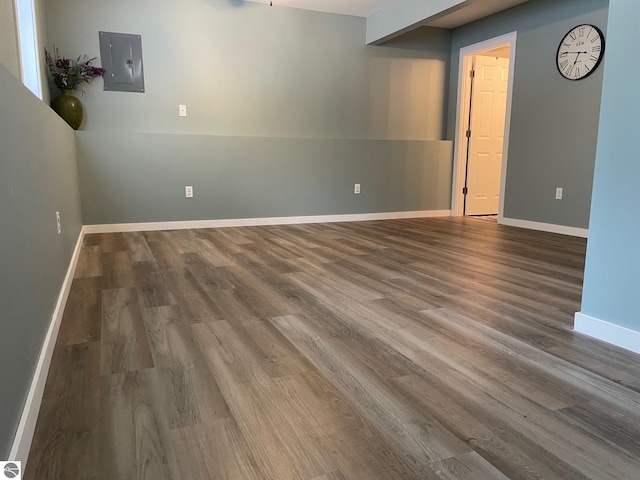 11893 Lillian Lee Dr, Interlochen, MI 49643 - spare room with electric panel, wood finished floors, and baseboards