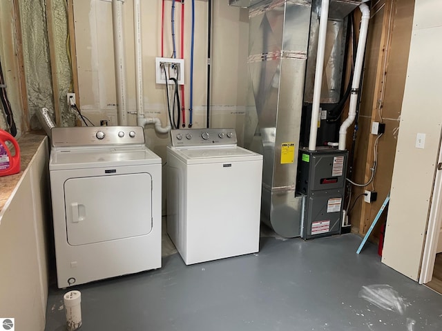 11893 Lillian Lee Dr, Interlochen, MI 49643 - clothes washing area with independent washer and dryer and heating unit