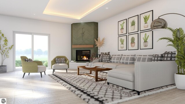 living area with a raised ceiling and a fireplace