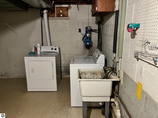 laundry area featuring cabinet space, washer and dryer, and a sink