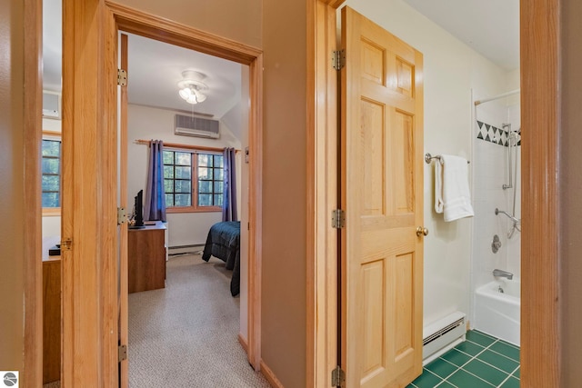hall featuring baseboard heating, an AC wall unit, a baseboard heating unit, and carpet floors