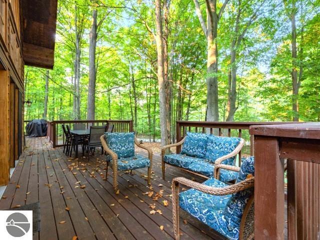 wooden terrace featuring outdoor dining area and an outdoor hangout area