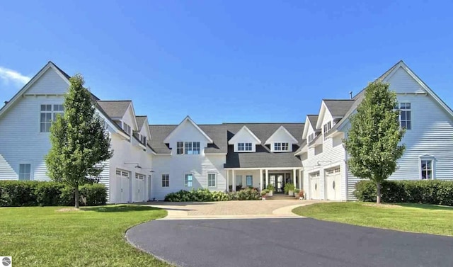 10292 E Fort Rd, Suttons Bay, MI 49682 - view of front of property featuring a garage, driveway, and a front lawn