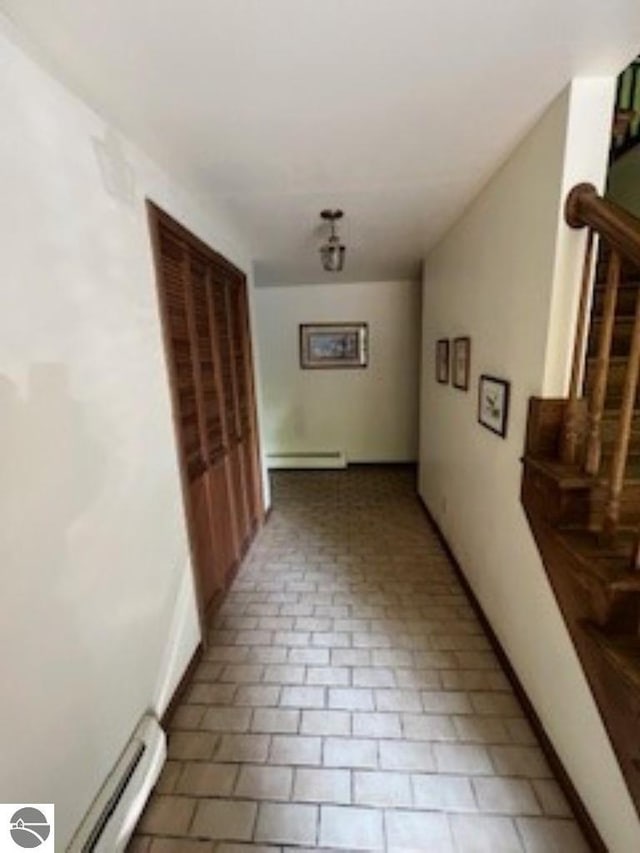 5016 Michabou Rd, Frankfort, MI 49635 - hall featuring a baseboard radiator and stairs