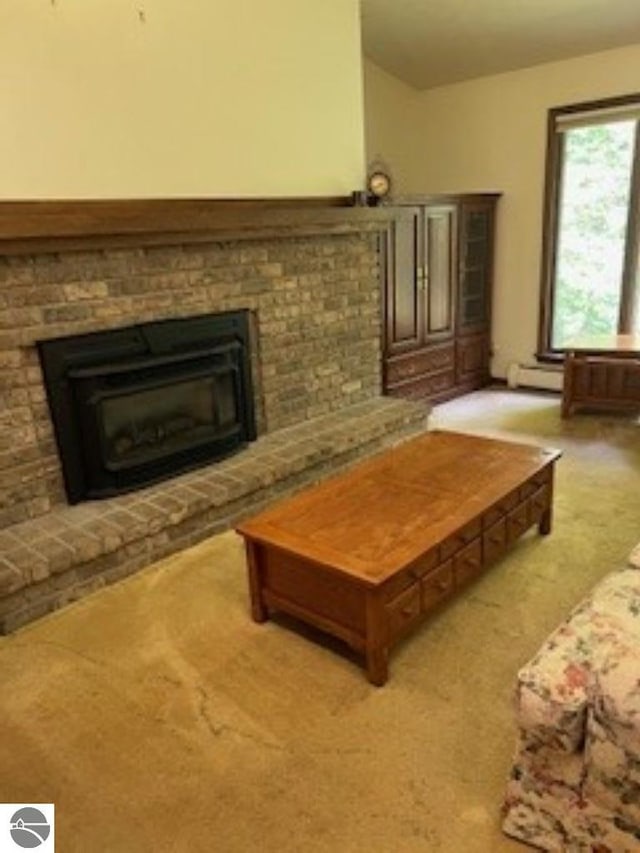 5016 Michabou Rd, Frankfort, MI 49635 - living room with a fireplace, lofted ceiling, baseboard heating, and light carpet