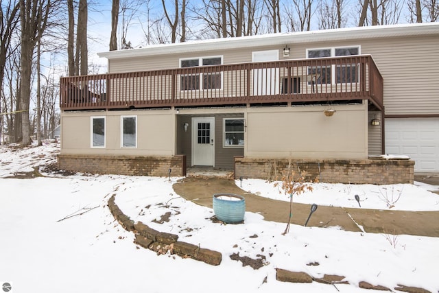 view of front of property featuring a garage and a wooden deck