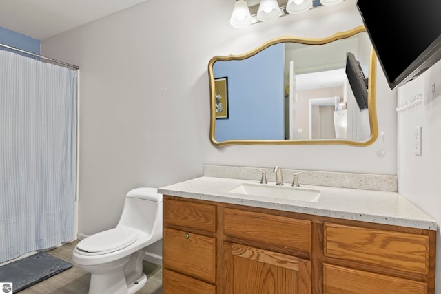 bathroom with vanity, a shower with shower curtain, and toilet