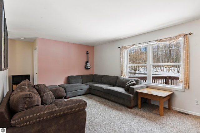 living room featuring carpet flooring, baseboards, and visible vents
