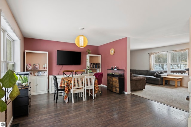 dining area with wood finished floors and baseboards
