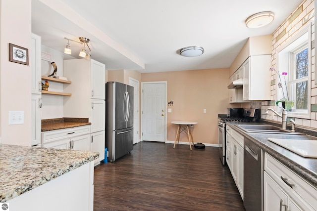 kitchen featuring a sink, stainless steel appliances, dark wood-style floors, white cabinetry, and open shelves