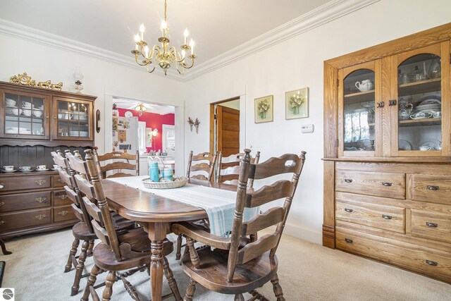 622 Leelanau Ave, Frankfort, MI 49635 - dining room with light carpet, a notable chandelier, baseboards, and ornamental molding