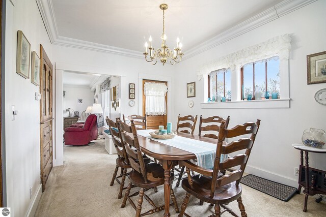 622 Leelanau Ave, Frankfort, MI 49635 - dining room with light colored carpet, baseboards, an inviting chandelier, and ornamental molding