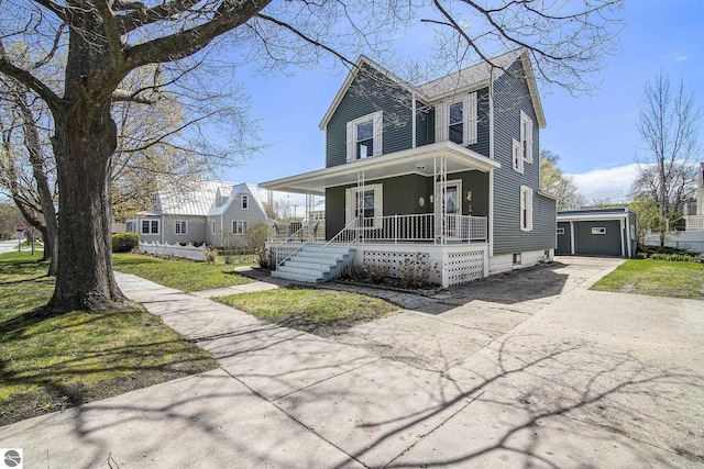622 Leelanau Ave, Frankfort, MI 49635 - view of front facade featuring an outbuilding, covered porch, and concrete driveway