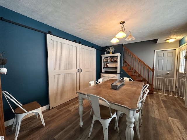 dining area with dark wood-type flooring, baseboards, stairs, and a textured ceiling