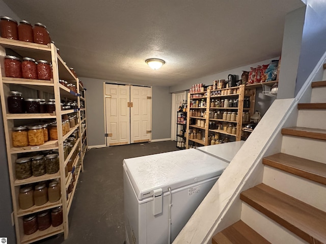 wine room with baseboards and a textured ceiling