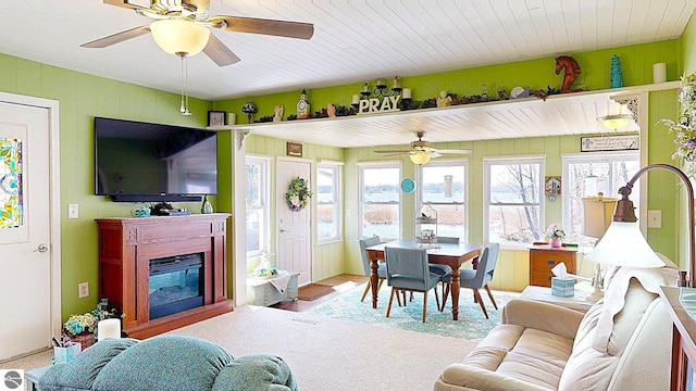 17429 Summit Ct, Barryton, MI 49305 - living room featuring a ceiling fan and a glass covered fireplace