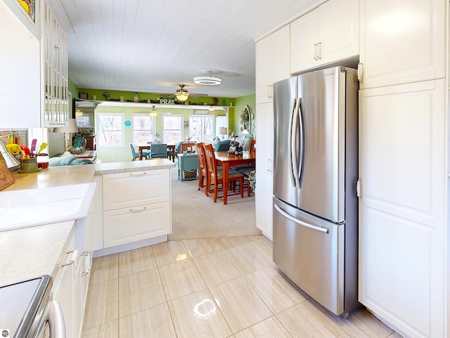 17429 Summit Ct, Barryton, MI 49305 - kitchen with freestanding refrigerator, light countertops, white cabinets, and electric range