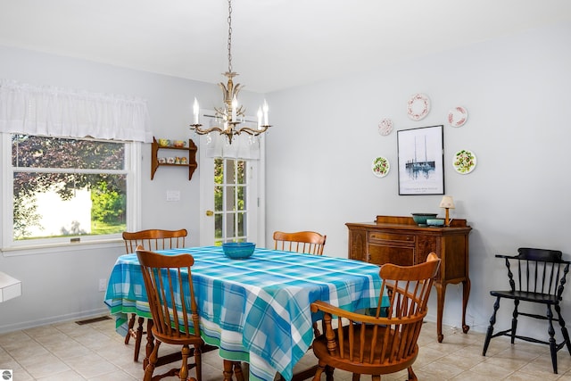 3275 S Sunrise Ln, Lake Leelanau, MI 49653 - dining room featuring light tile patterned floors, baseboards, a chandelier, and visible vents