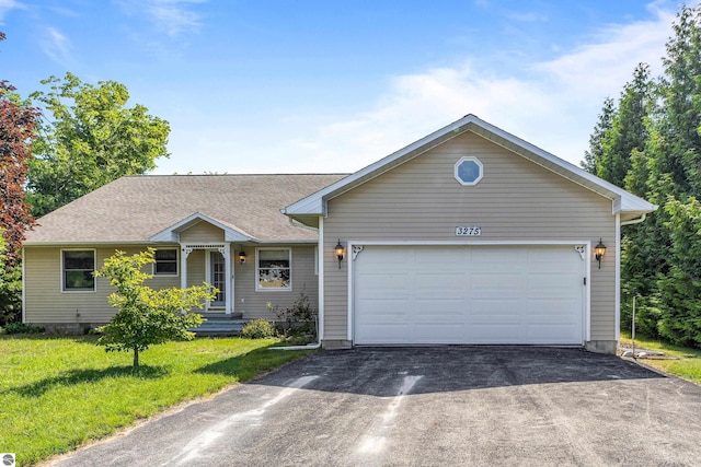 3275 S Sunrise Ln, Lake Leelanau, MI 49653 - ranch-style house featuring a shingled roof, driveway, a front lawn, and an attached garage