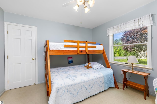 3275 S Sunrise Ln, Lake Leelanau, MI 49653 - carpeted bedroom with baseboards and a ceiling fan