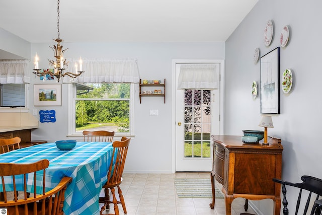 3275 S Sunrise Ln, Lake Leelanau, MI 49653 - dining space featuring baseboards, a wealth of natural light, an inviting chandelier, and light tile patterned floors