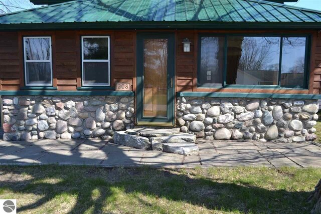 back of property featuring metal roof