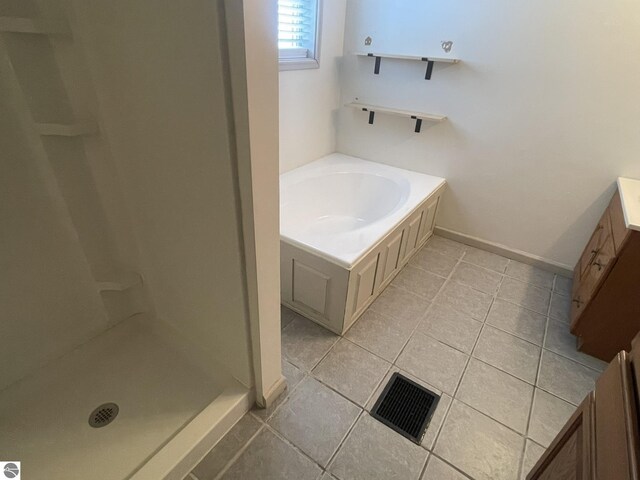 full bathroom featuring a bath, visible vents, a shower stall, baseboards, and tile patterned floors