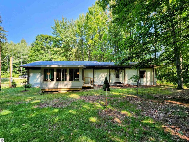 8468 Shorewood Ct, Mancelona, MI 49659 - view of front of home with a front yard