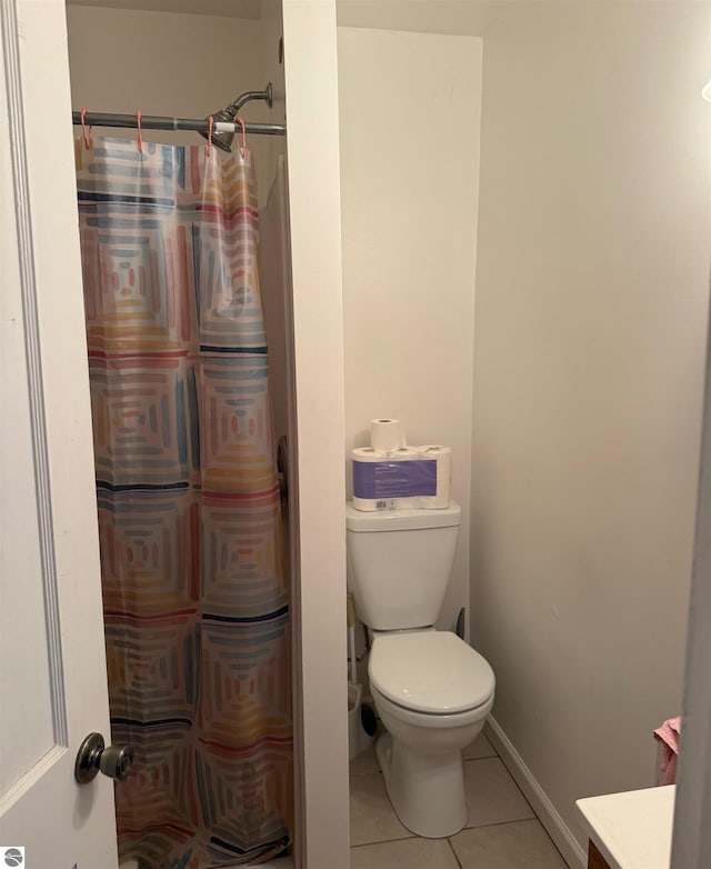 6133 W Airline Rd, Weidman, MI 48893 - full bath with a shower with shower curtain, baseboards, toilet, tile patterned floors, and vanity