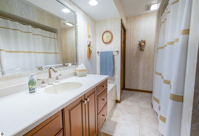 full bathroom featuring tile patterned floors, vanity, a shower with shower curtain, and wallpapered walls